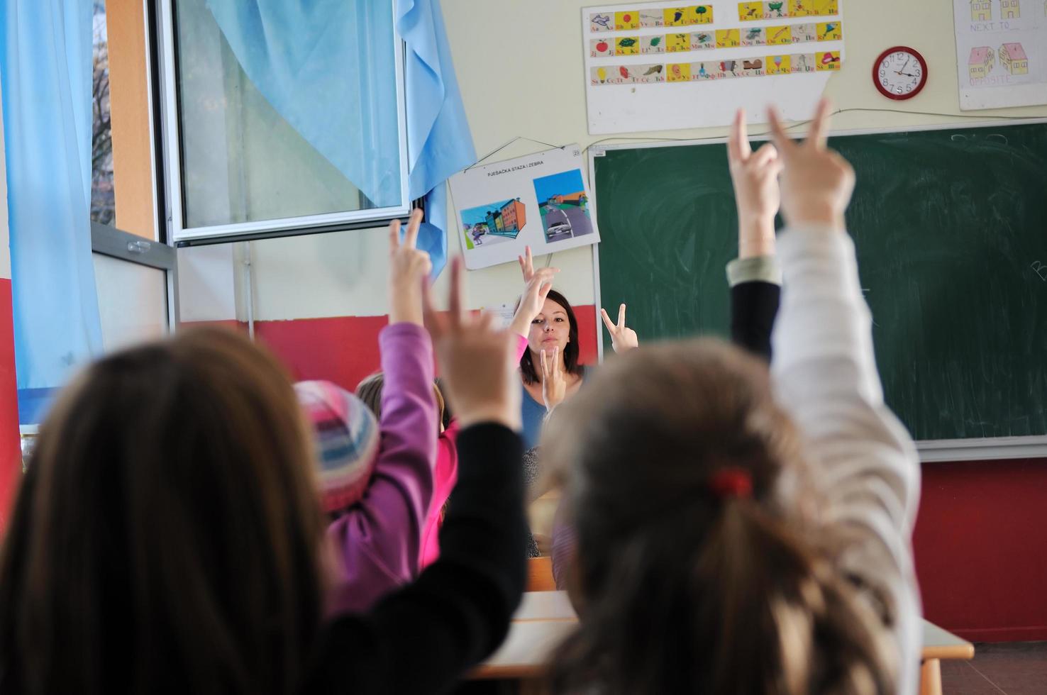 happy teacher in  school classroom photo