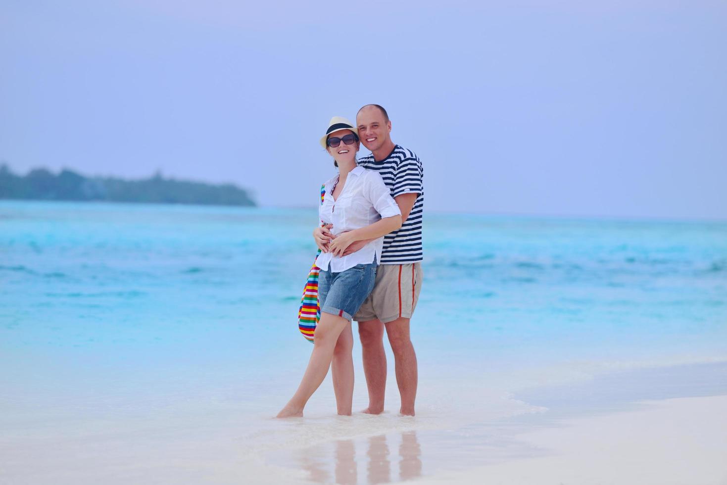 happy young couple have fun on beach photo