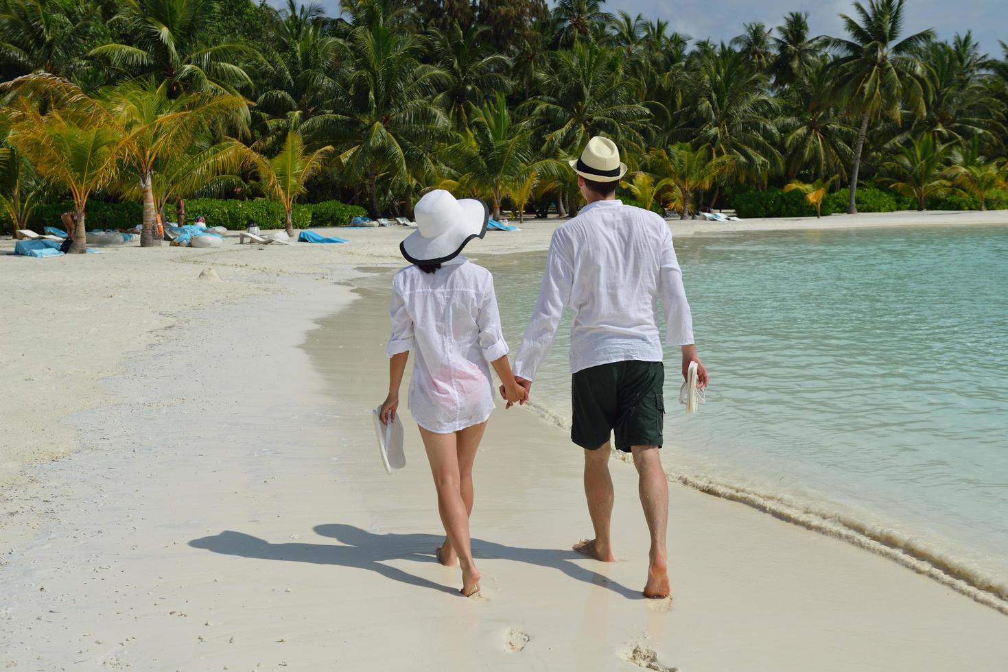 happy young couple have fun on beach photo