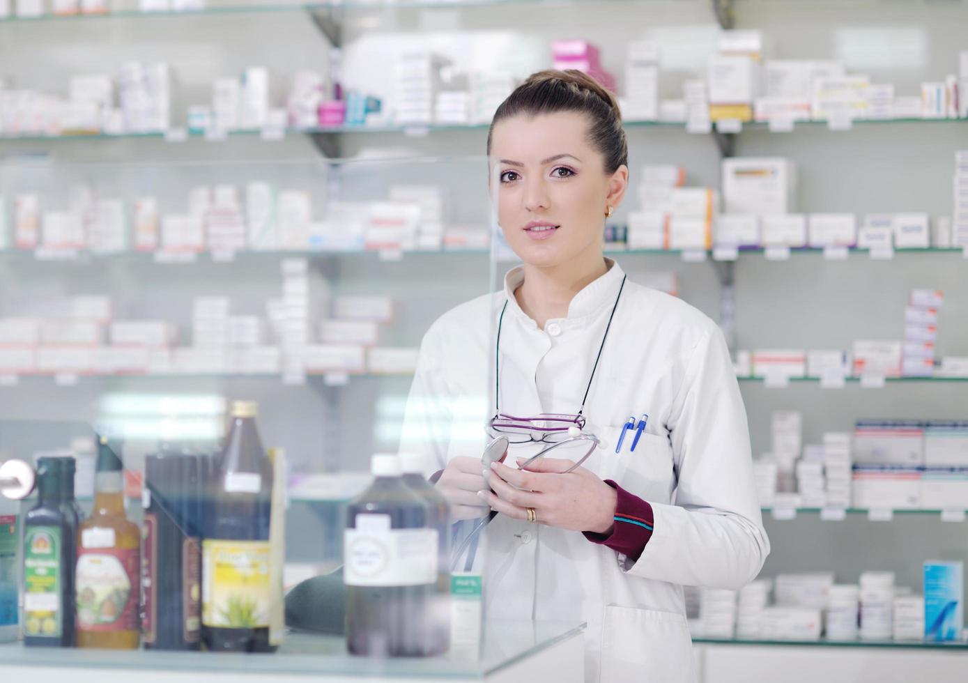 pharmacist chemist woman standing in pharmacy drugstore photo