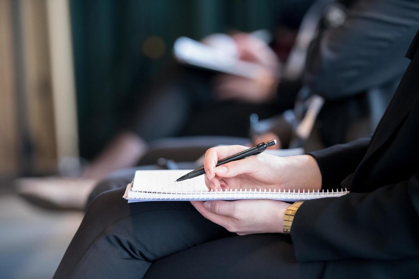 close up of business people taking notes photo