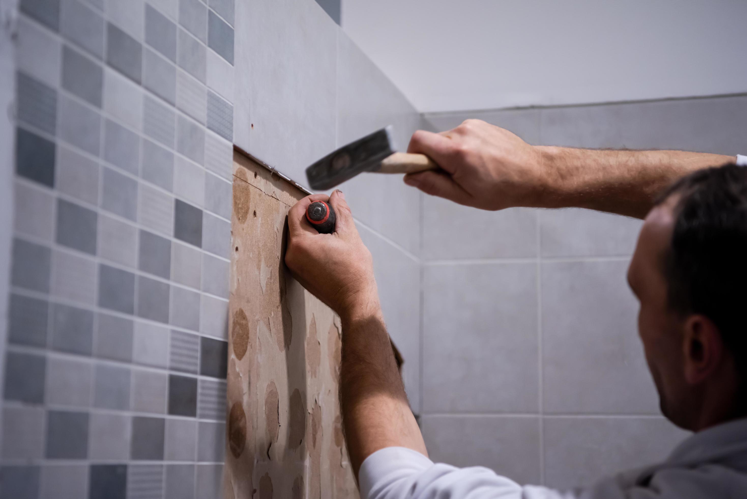 worker remove demolish old tiles in a bathroom 11916658 Stock Photo at