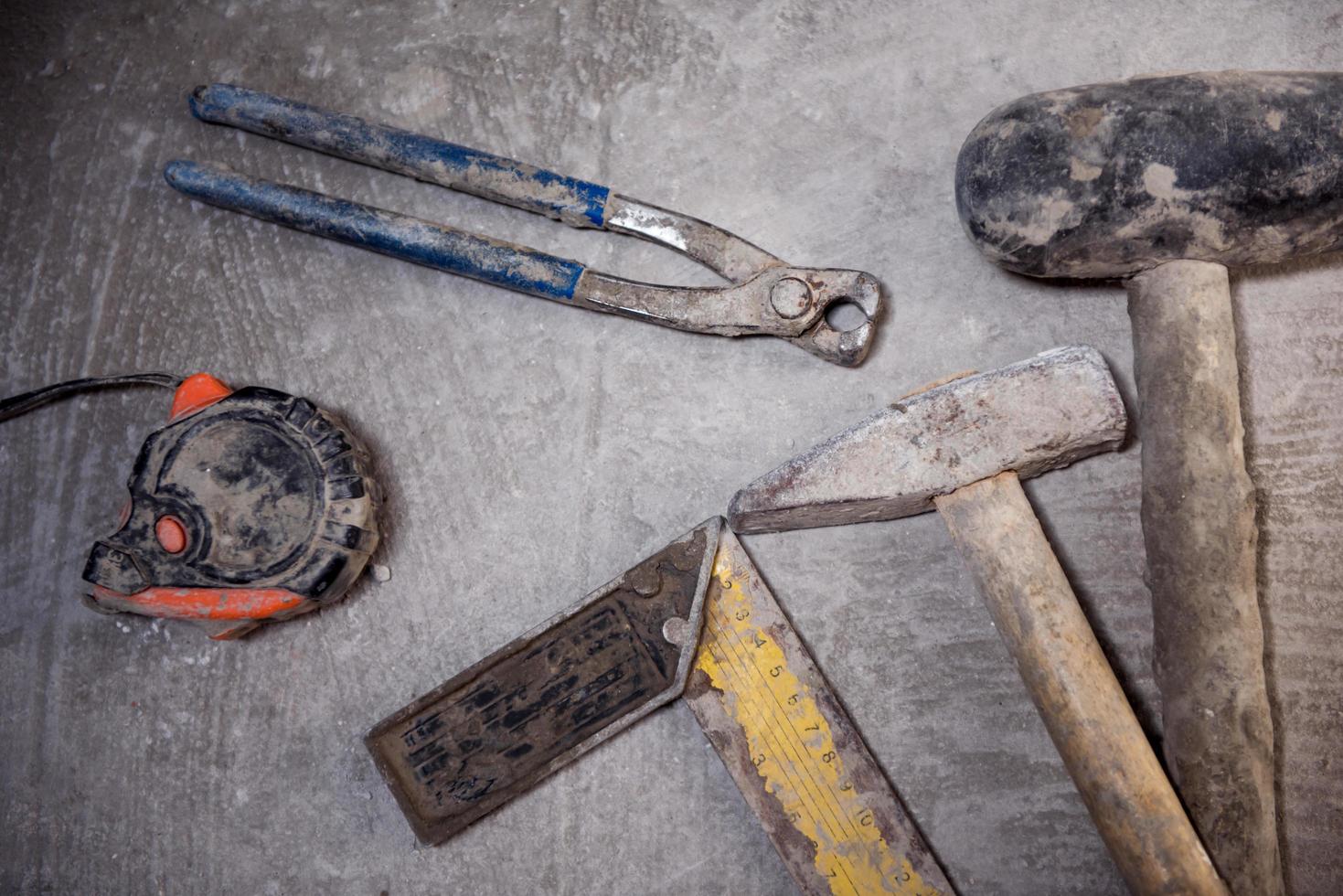 set of hand working tools on concrete background photo
