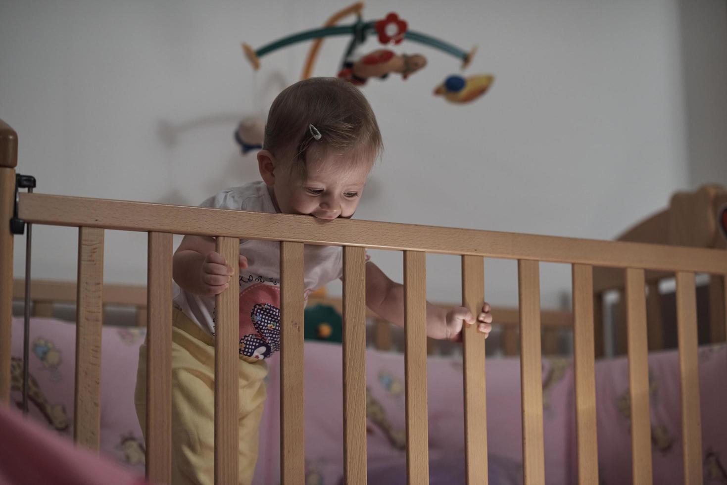 cute  little one year old baby and making first steps in bed photo