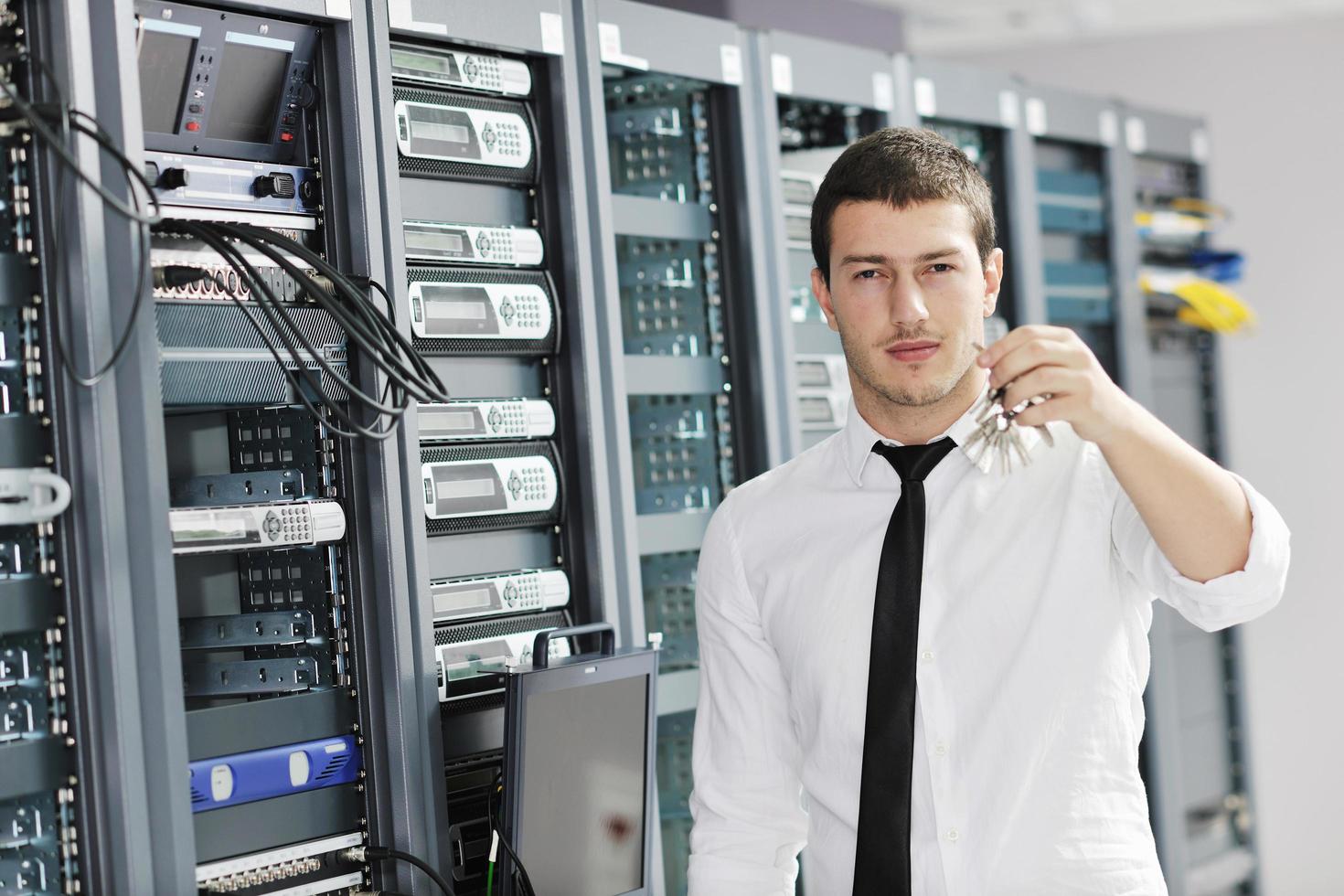 young it engeneer in datacenter server room photo