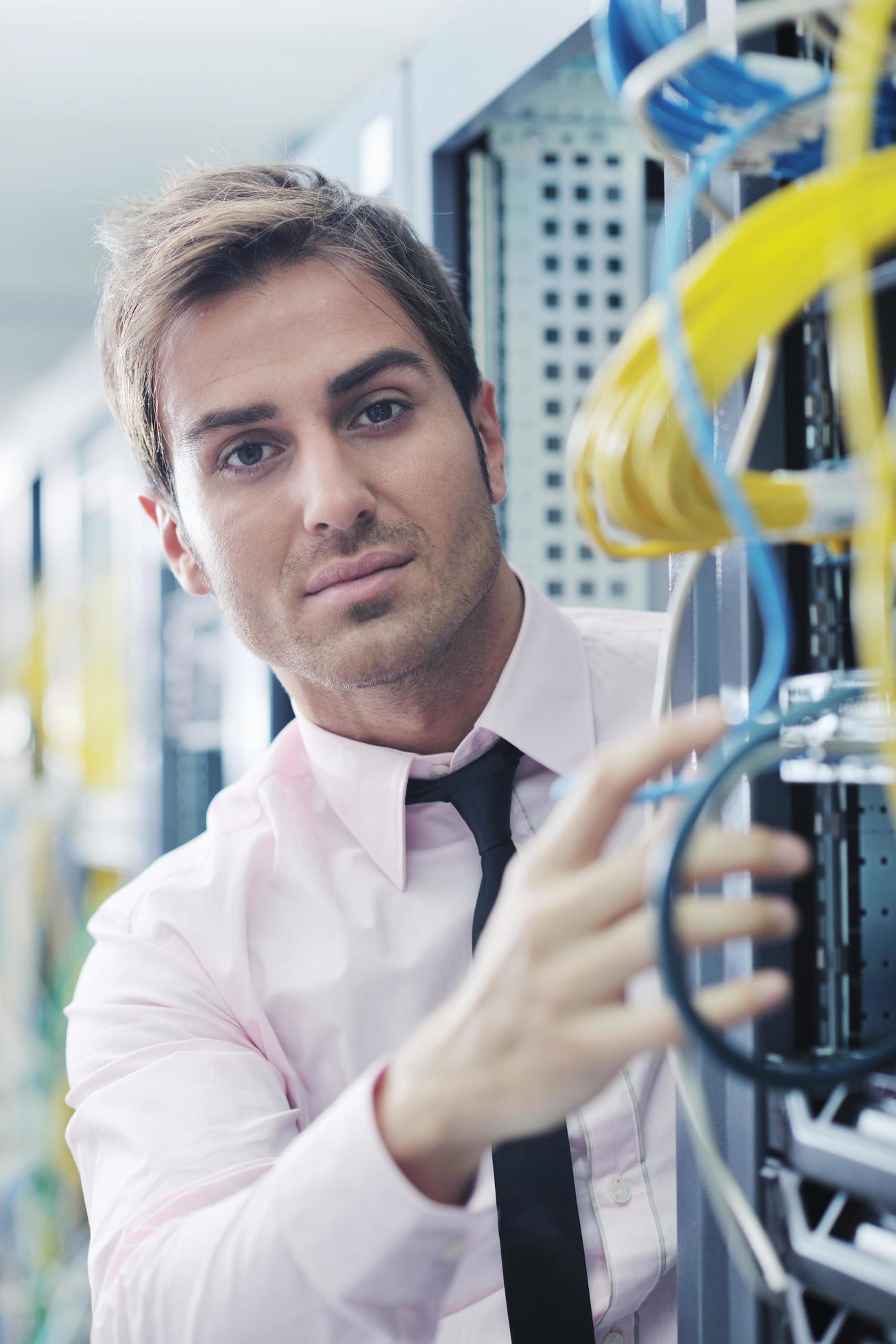 young it engeneer in datacenter server room 11919263 Stock Photo at