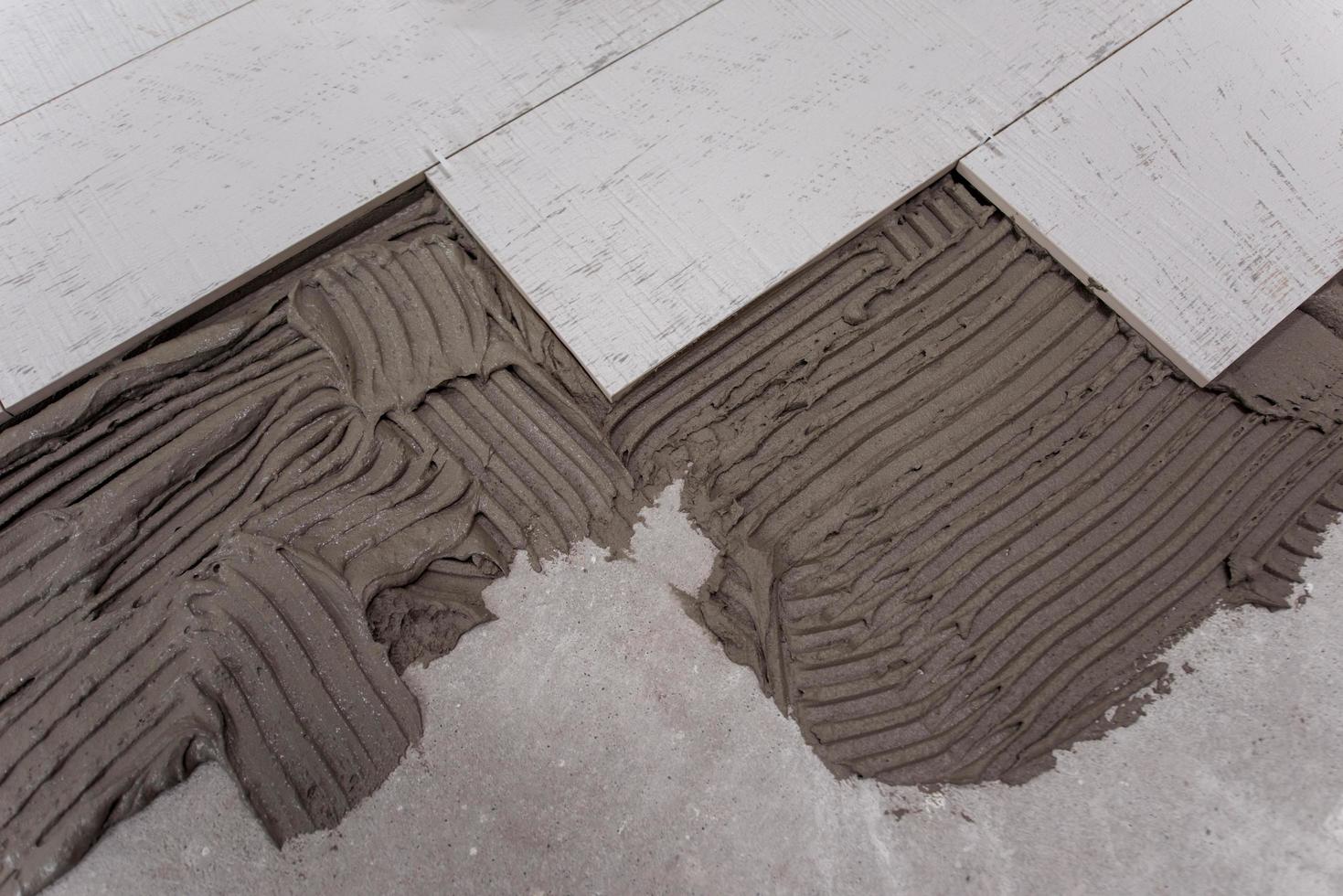 Ceramic wood effect tiles and tools for tiler on the floor photo