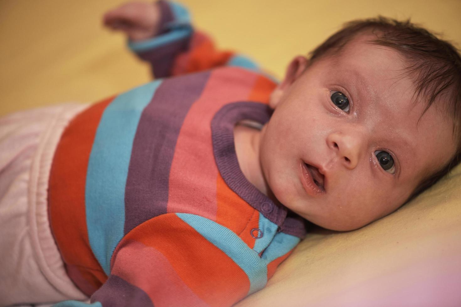 One month newborn baby sleeping  in bed photo