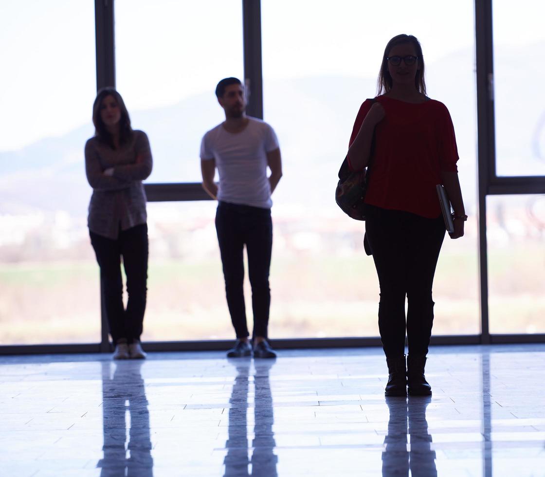 student girl standing with laptop, people group passing by photo