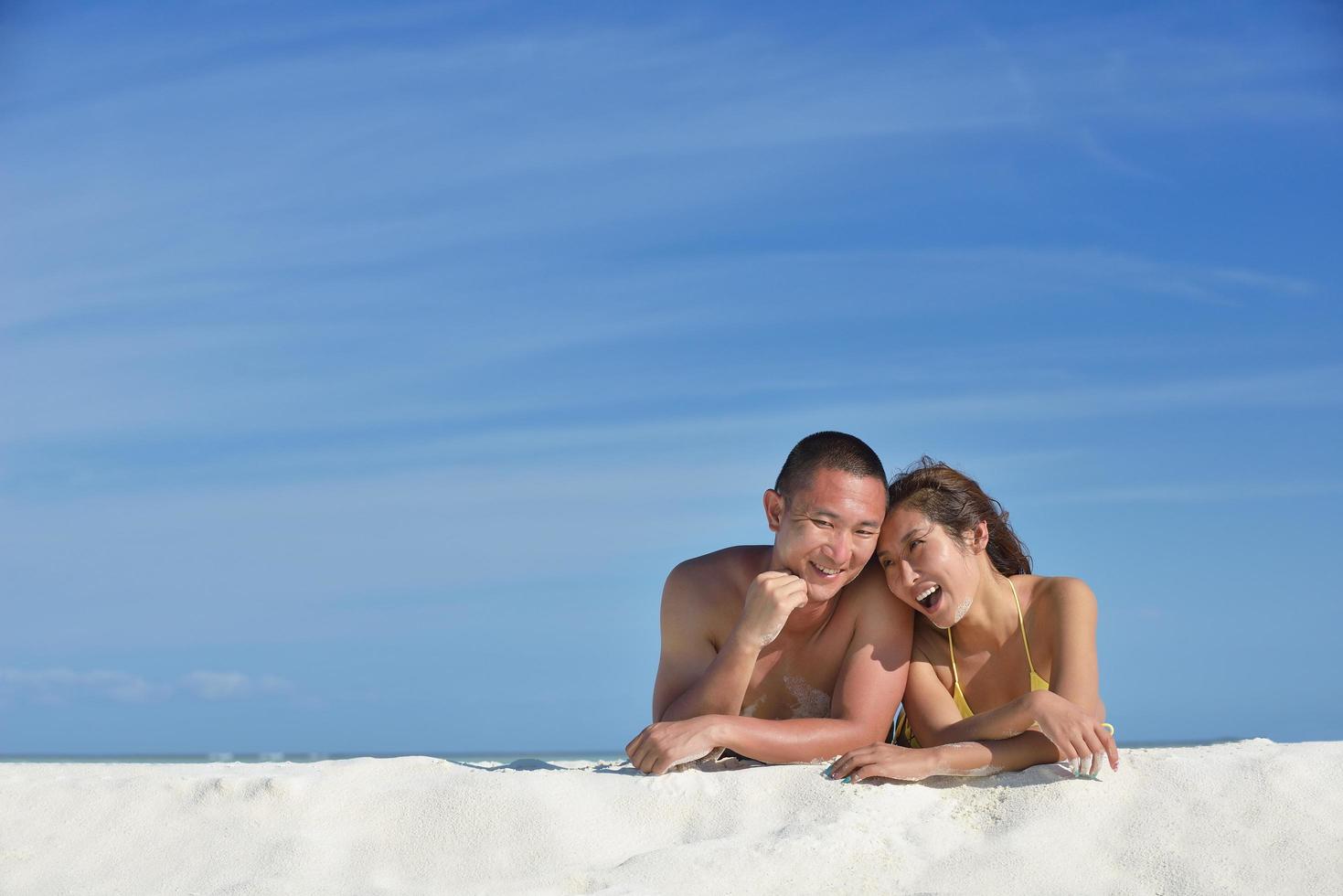 happy young  couple enjoying summer on beach photo