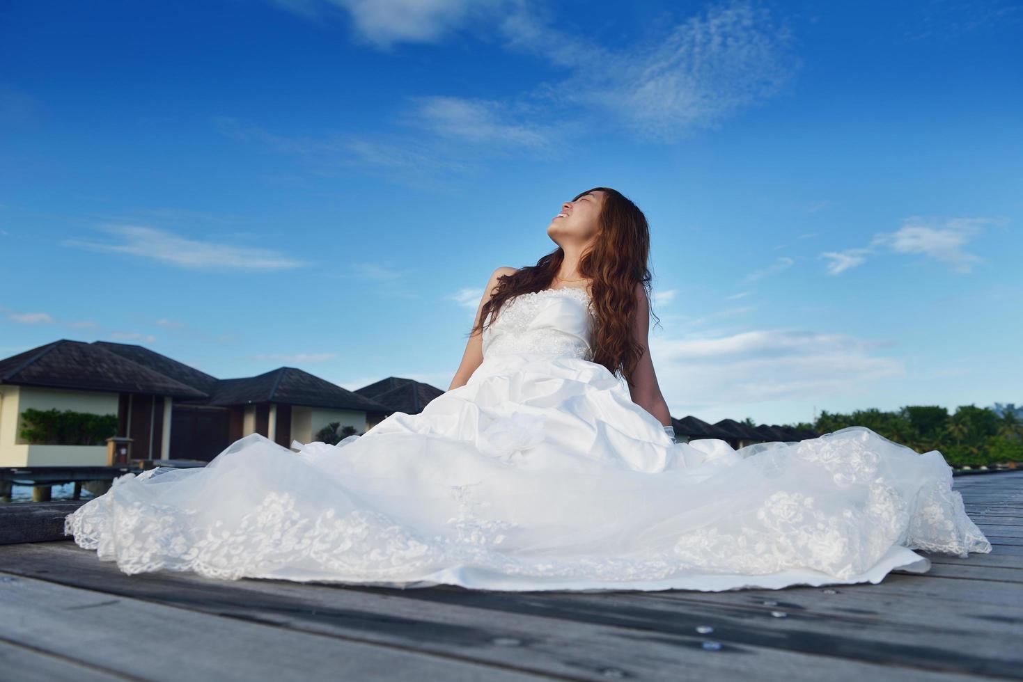 asian bride on beach photo