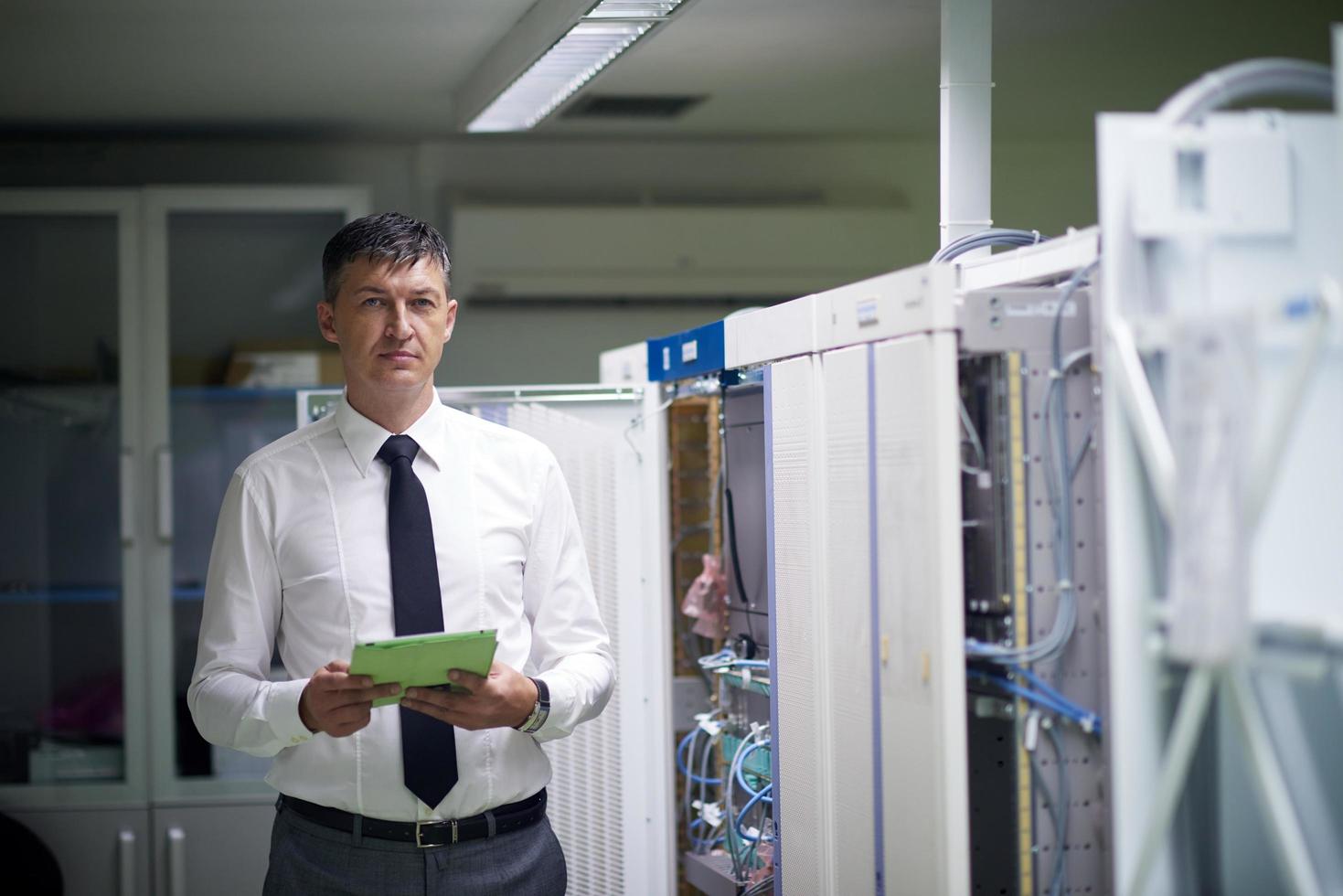 network engineer working in  server room photo