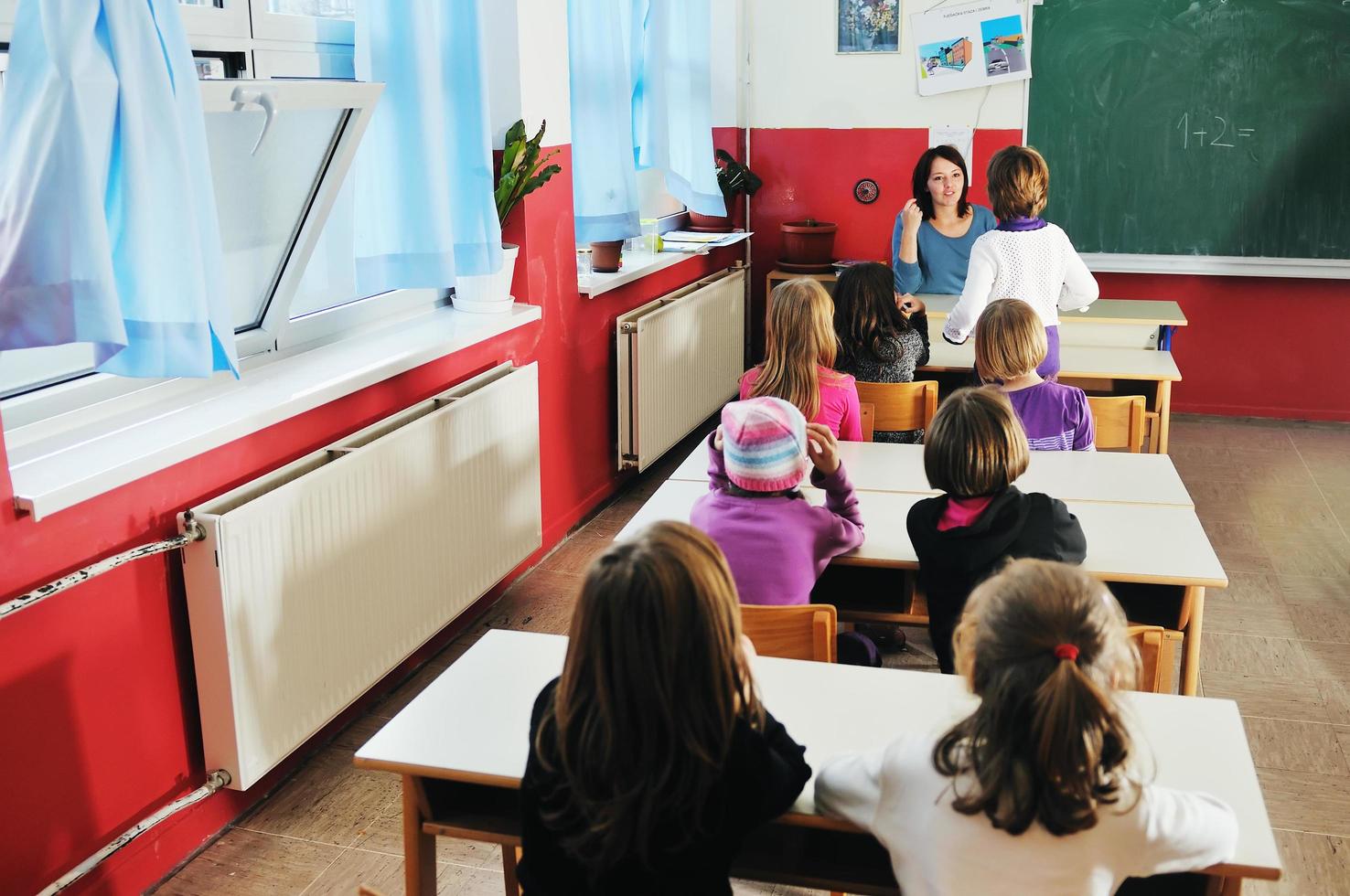 happy teacher in  school classroom photo