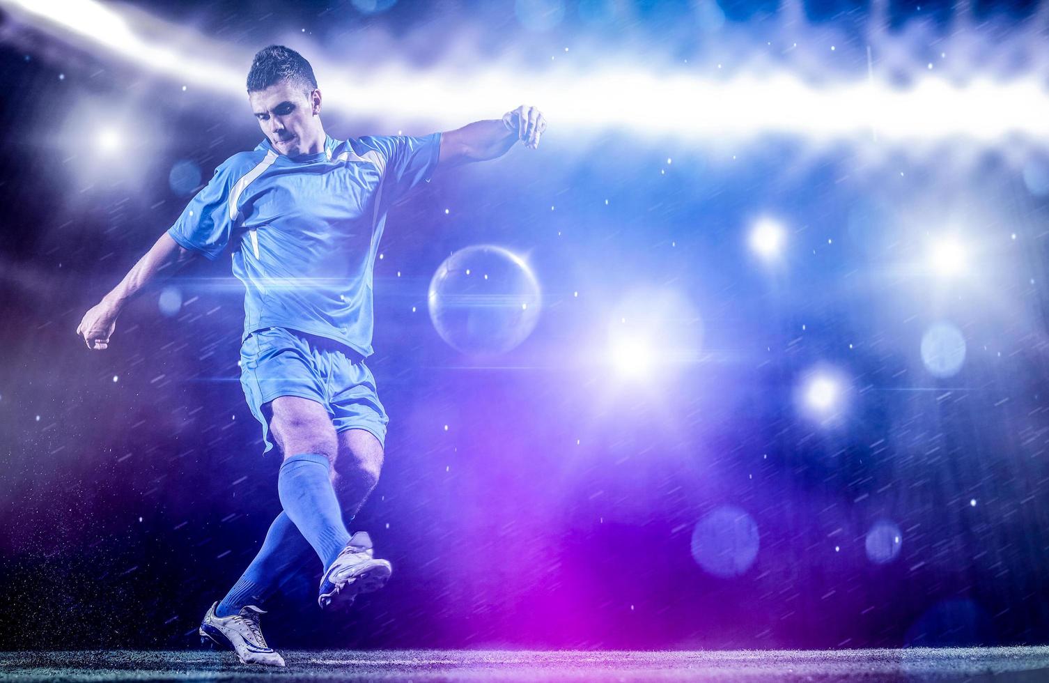 soccer player in front of big modern stadium with flares and lights photo