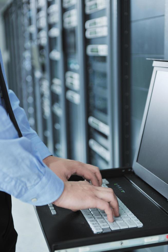young it engeneer in datacenter server room photo