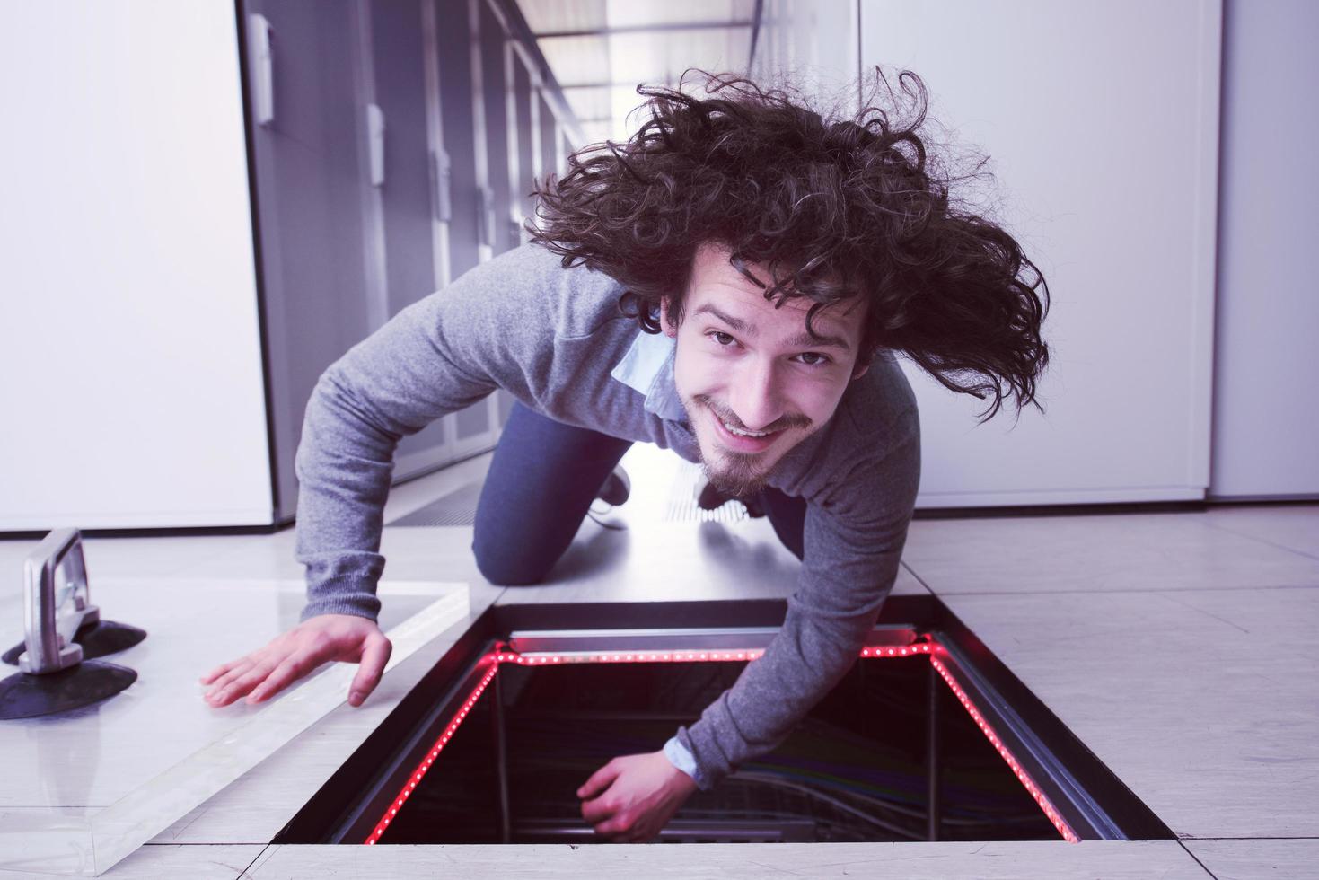 engineer connecting cables in server room photo