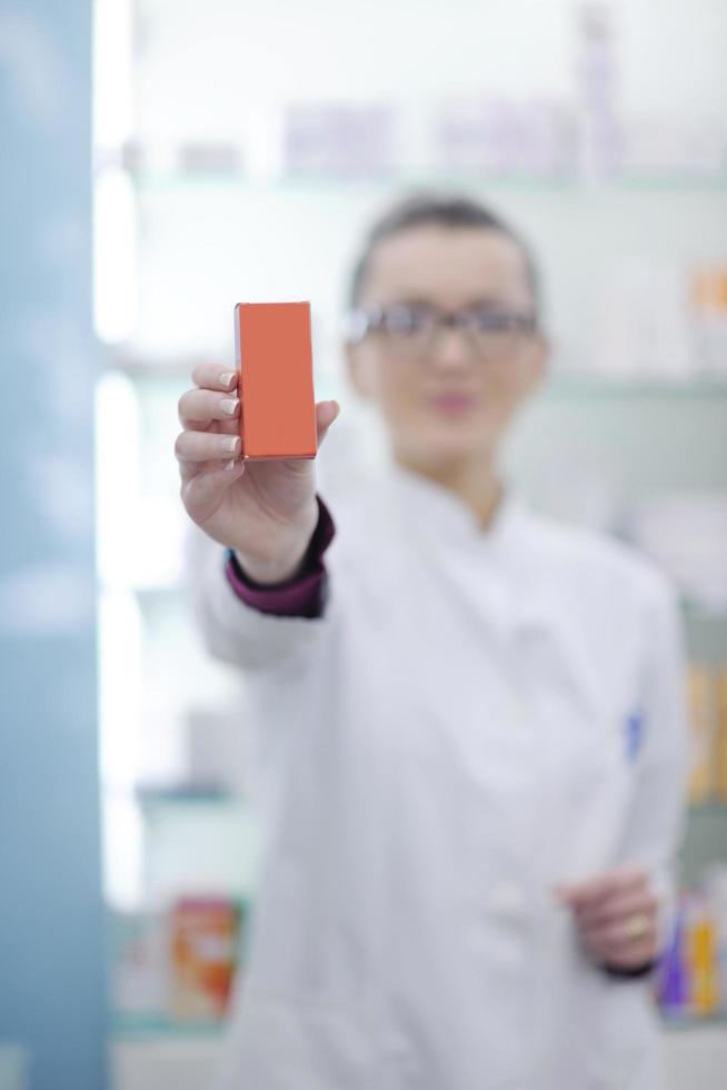 pharmacist chemist woman standing in pharmacy drugstore photo