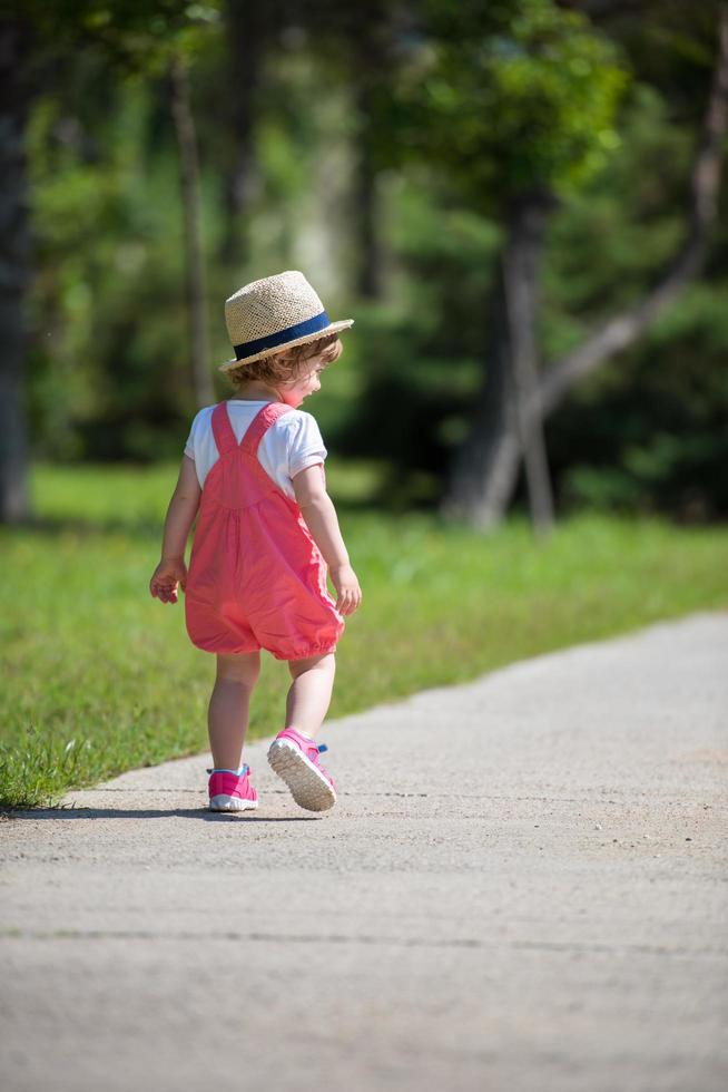 little girl runing in the summer Park photo