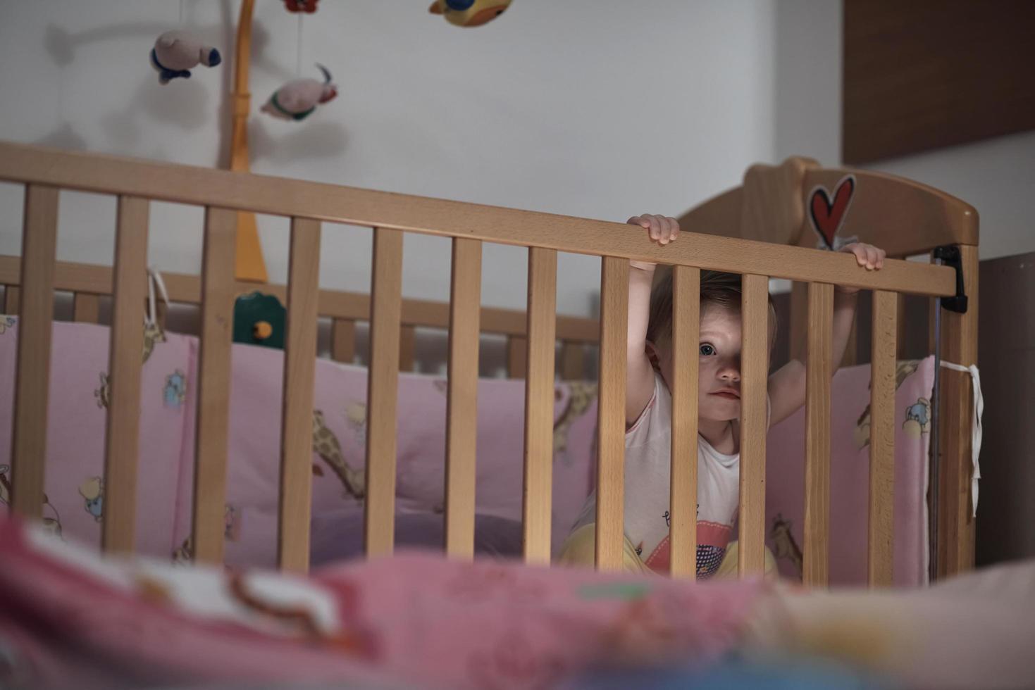 cute  little one year old baby and making first steps in bed photo