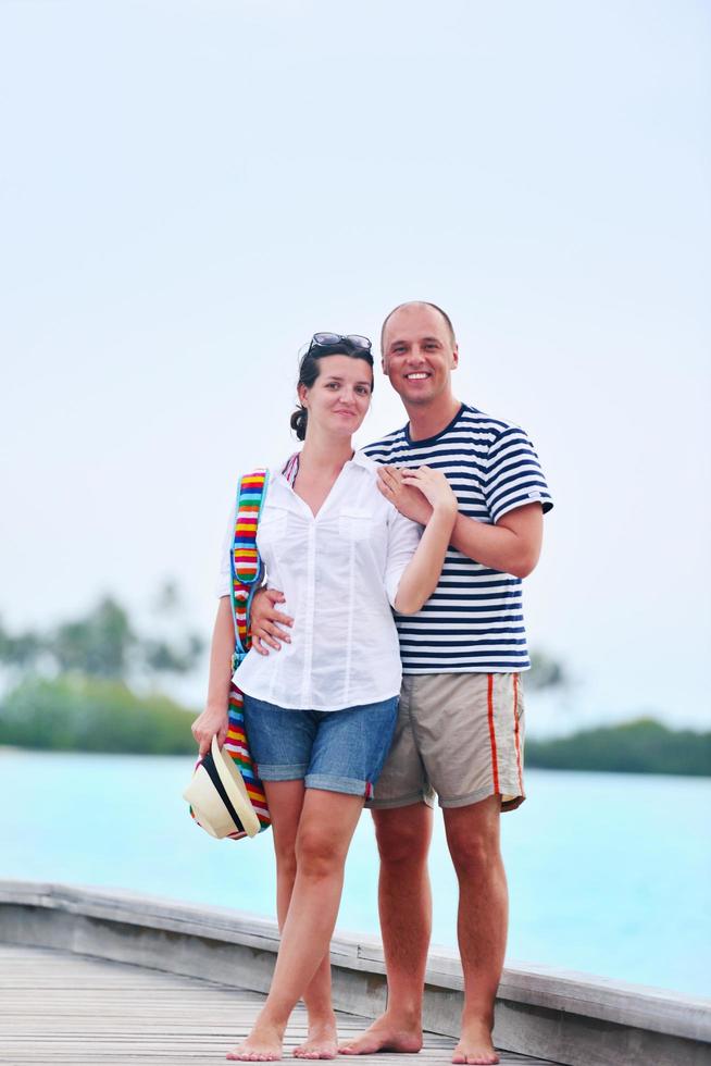 happy young couple have fun on beach photo