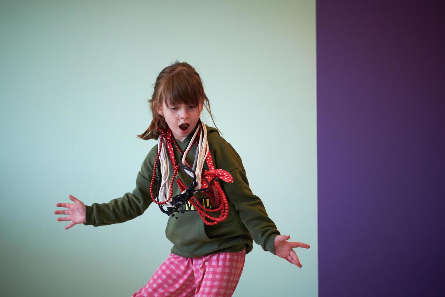 girl having fun and dancing wearing mothers jewelry photo