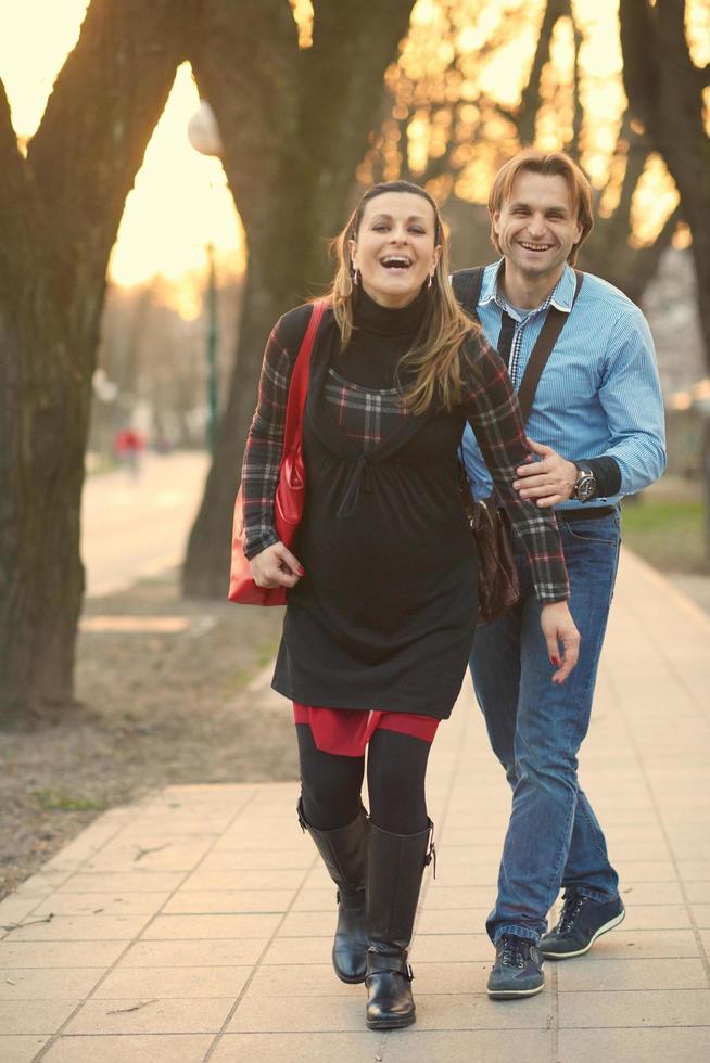 young pregnant couple have fun and relax photo