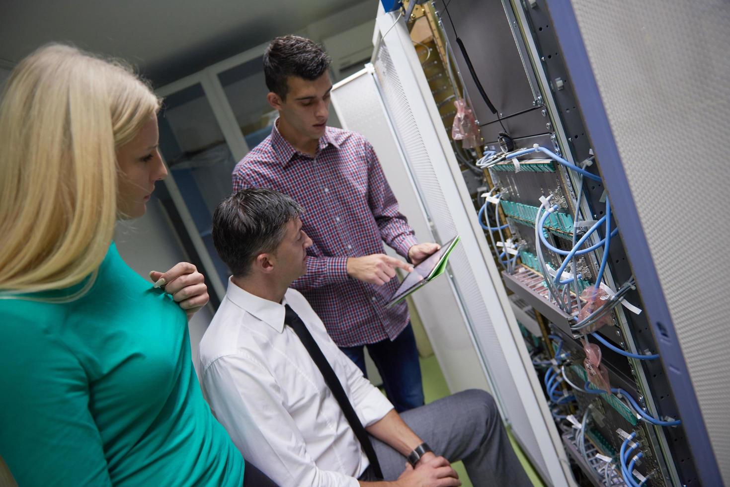 network engeneers working in network server room photo