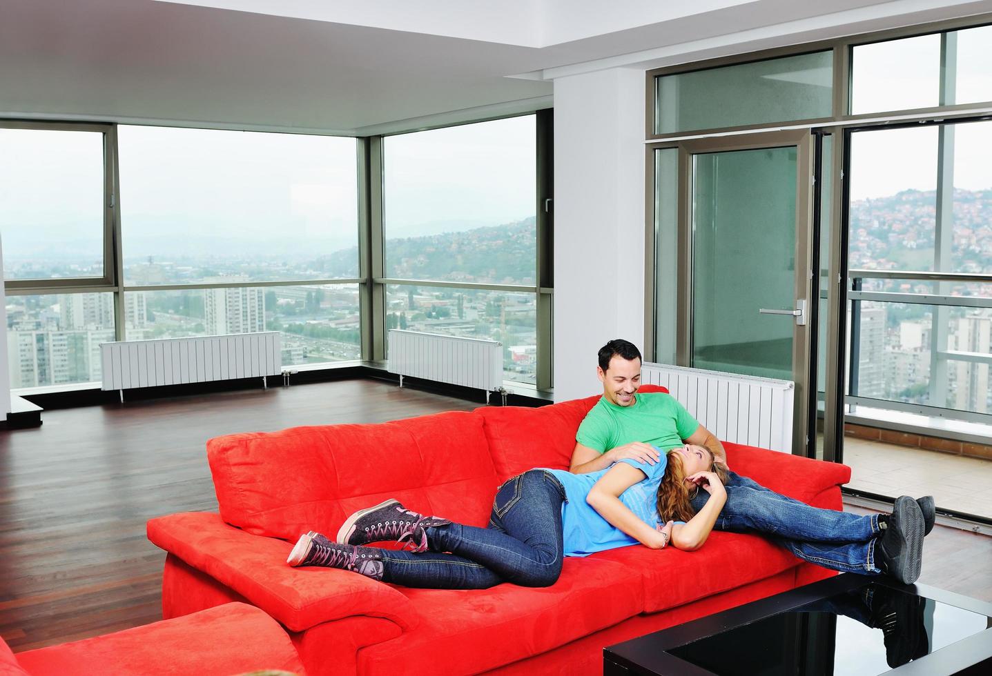 happy couple relax on red sofa photo