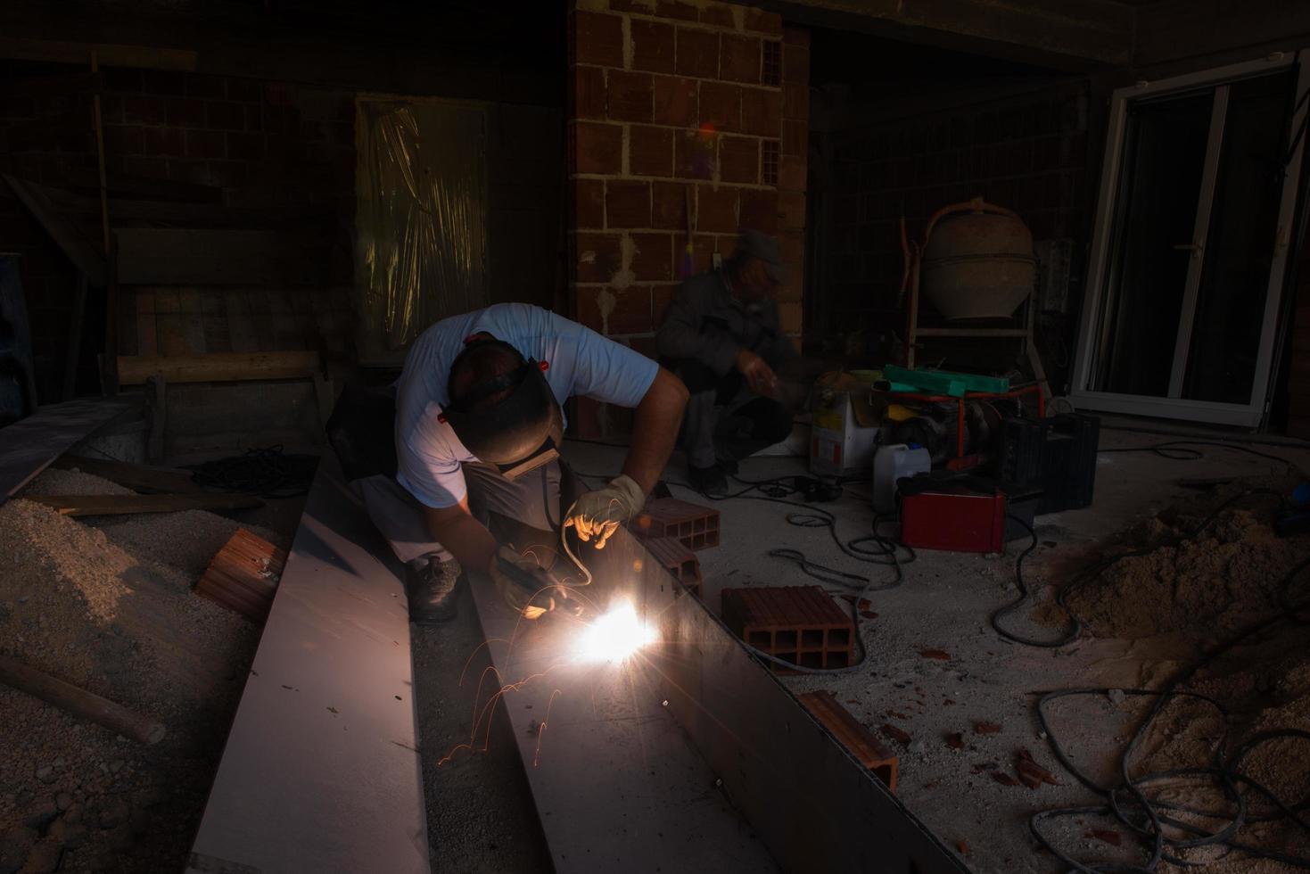 welder with protective mask welding steel photo