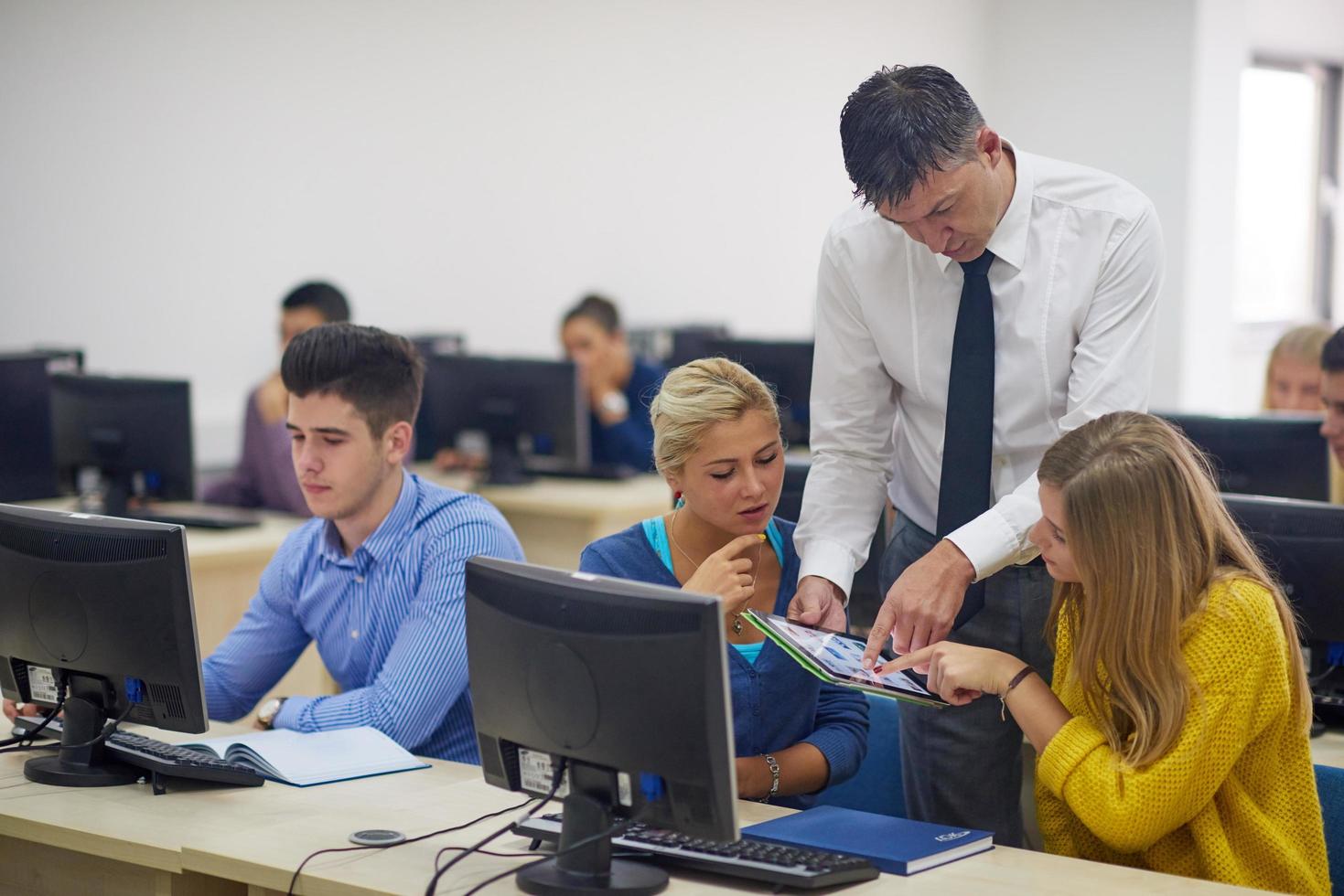 students with teacher  in computer lab classrom photo