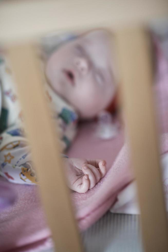 newborn baby sleeping  at home in bed photo