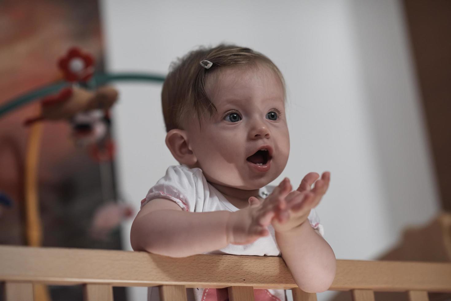 cute  little one year old baby and making first steps in bed photo