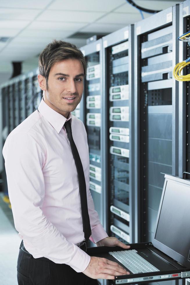 young it engeneer in datacenter server room photo