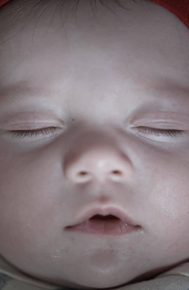 newborn baby sleeping  at home in bed photo