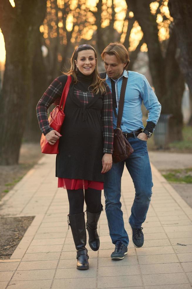 young pregnant couple have fun and relax photo