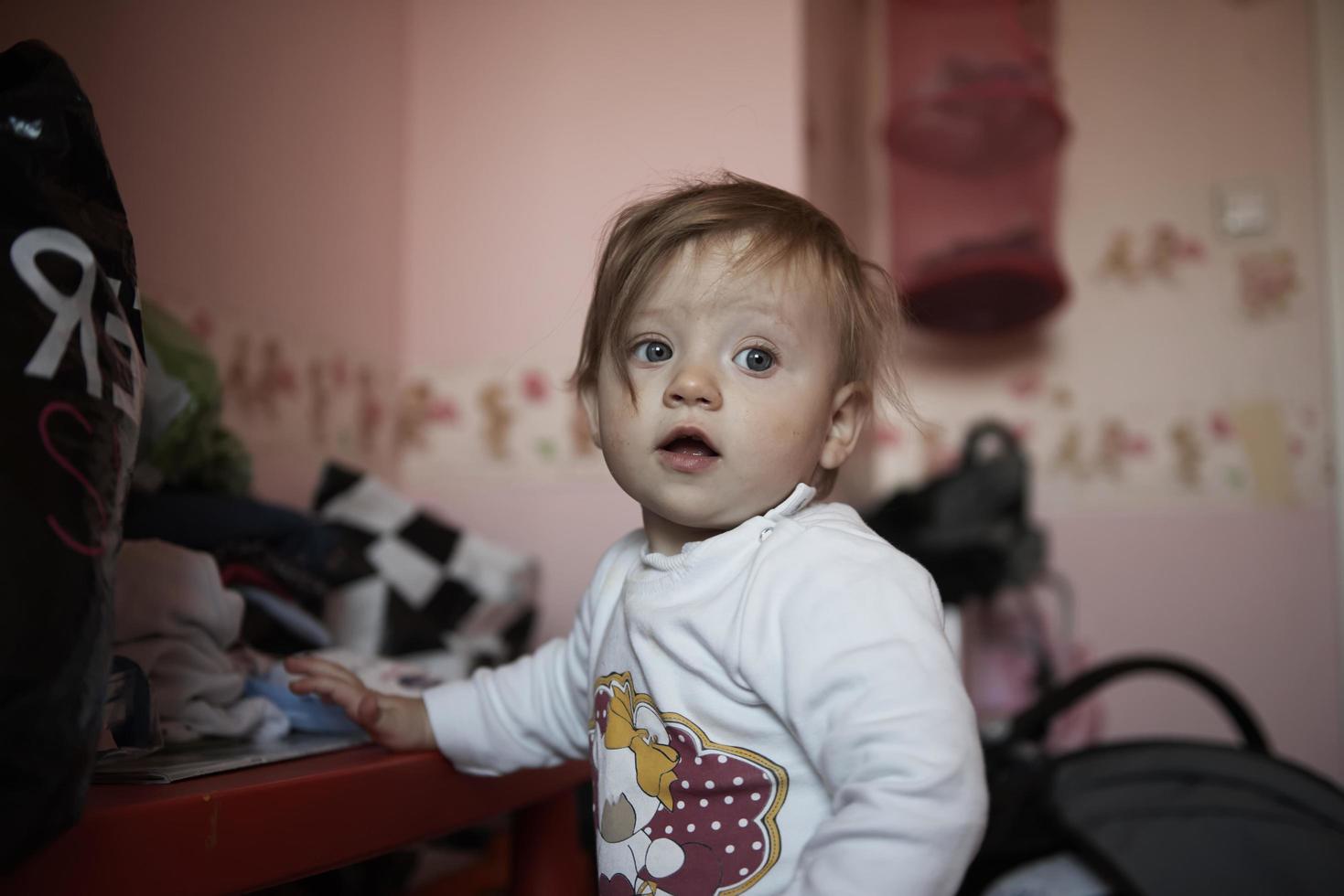 cute  little one year old baby and making first steps photo