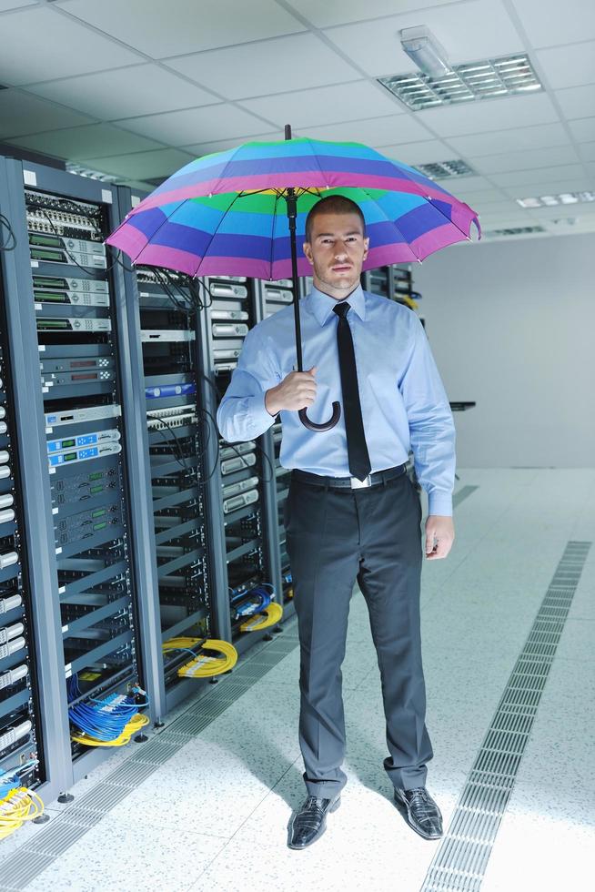 businessman hold umbrella in server room photo