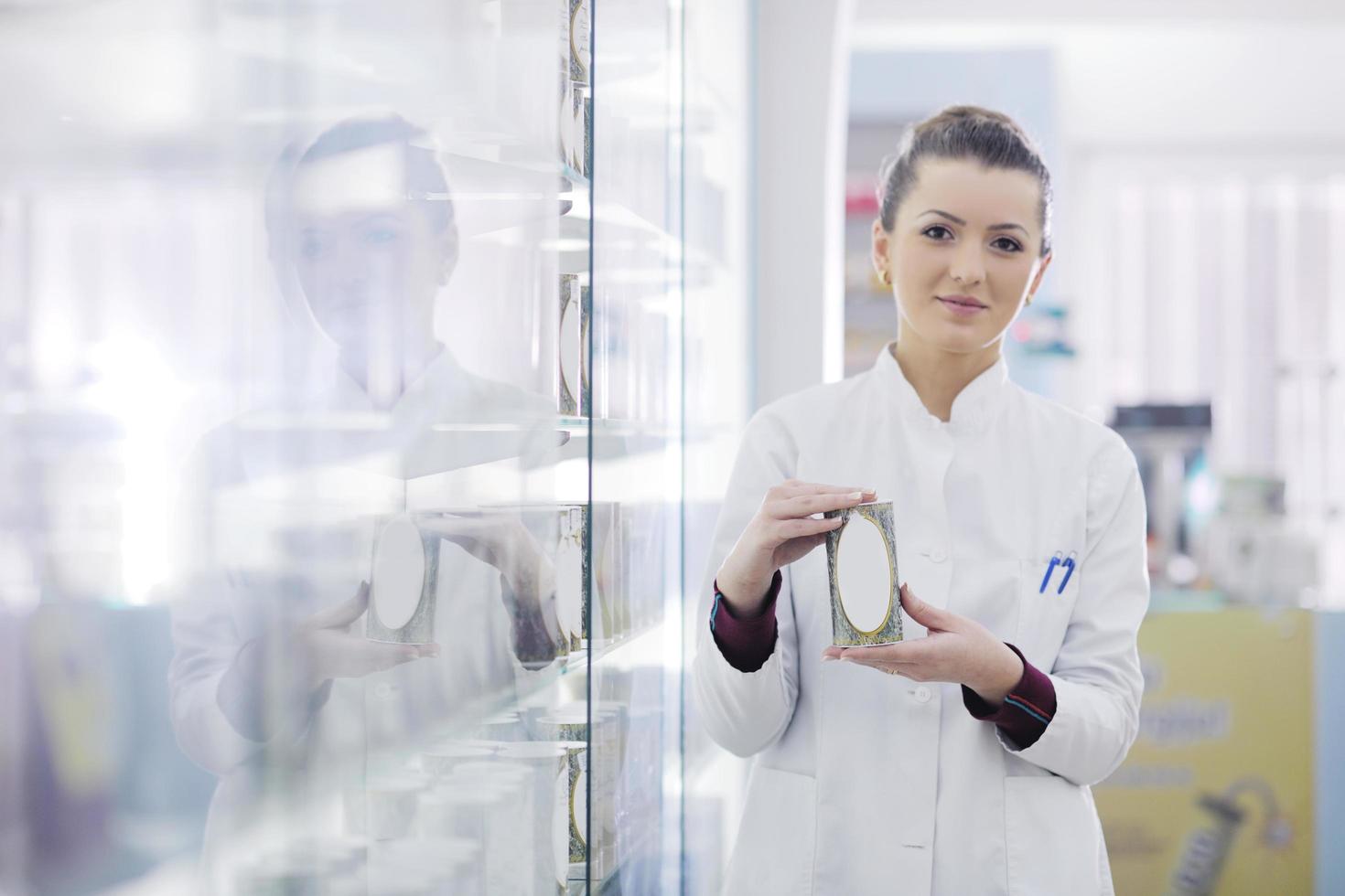 pharmacist chemist woman standing in pharmacy drugstore photo