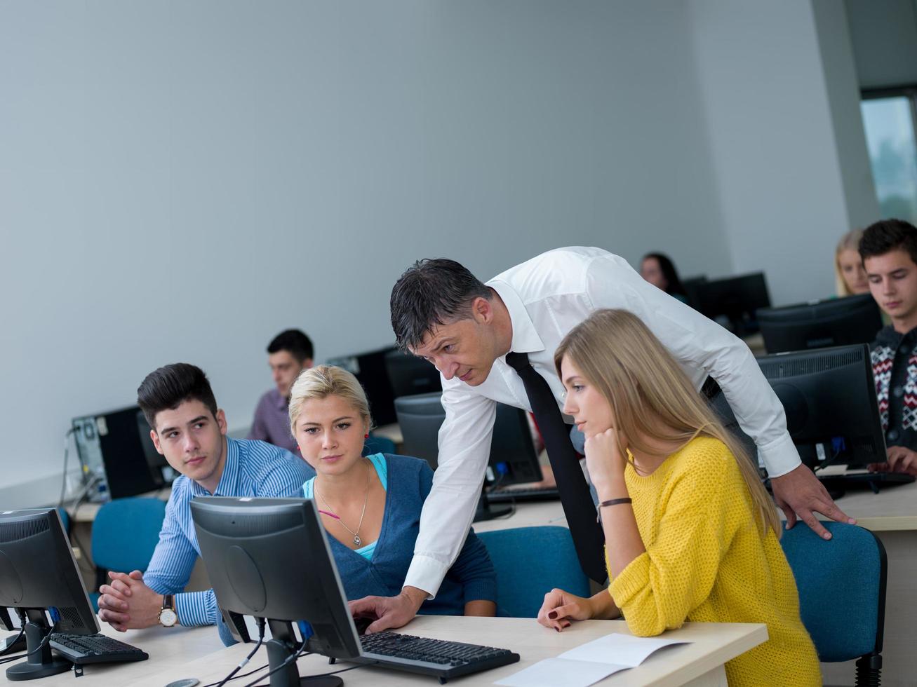 students with teacher  in computer lab classrom photo