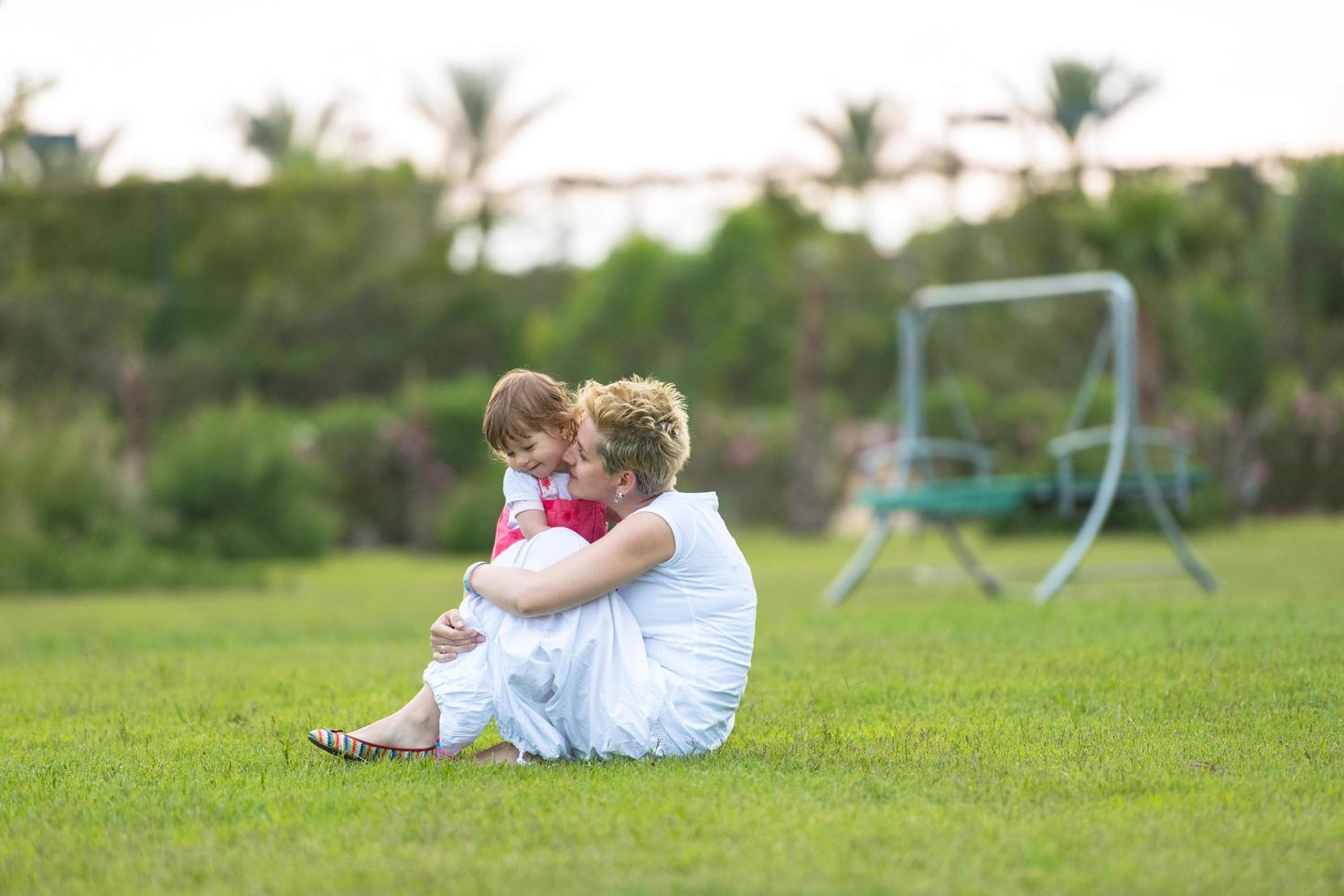 mother and little daughter playing at backyard photo