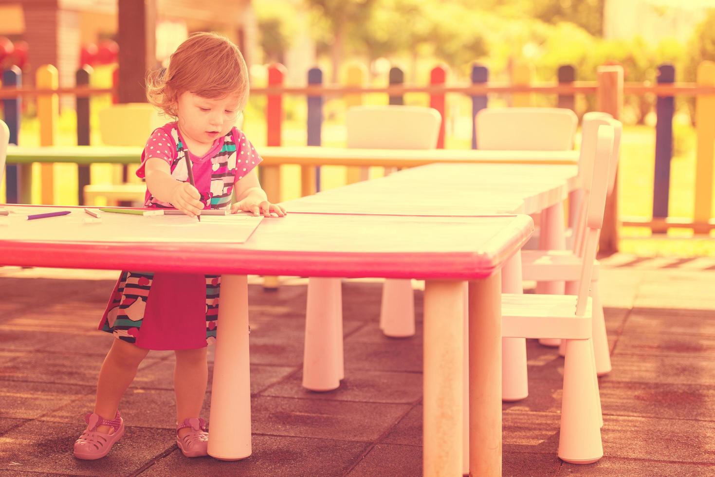 little girl drawing a colorful pictures photo