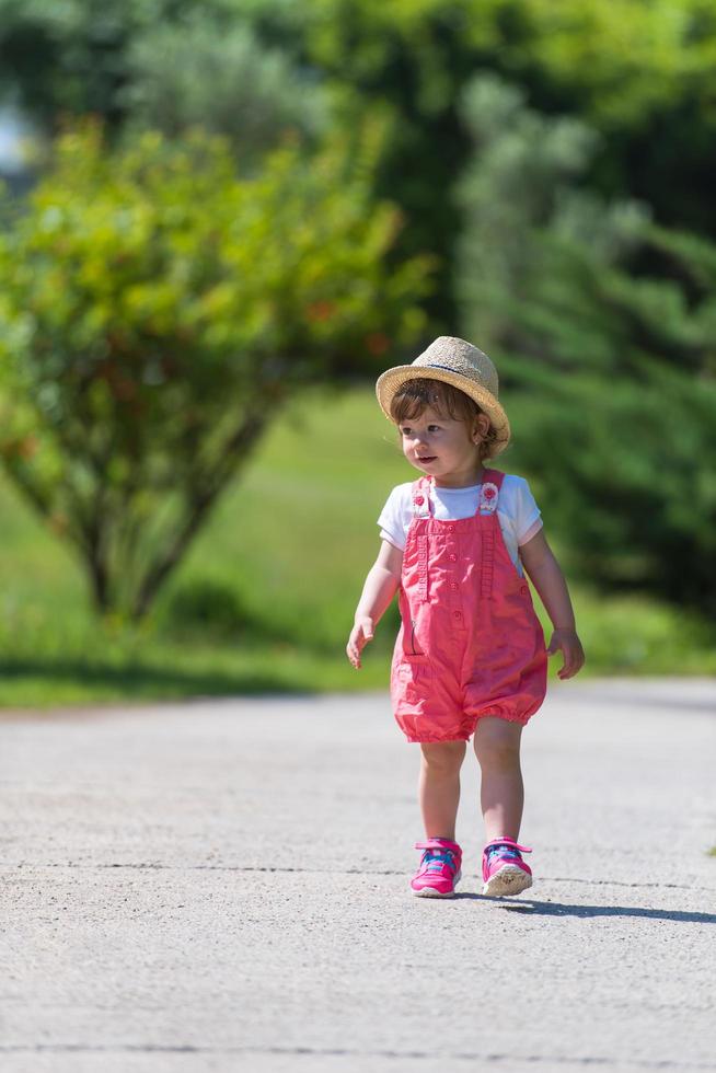 little girl runing in the summer Park photo