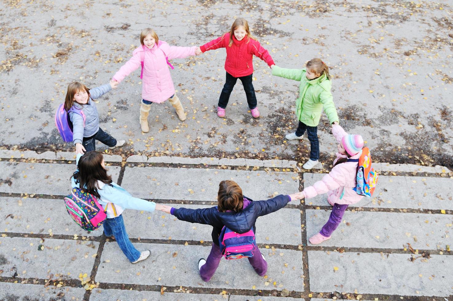 friendship and teamwork concept with young schoolgirls group photo