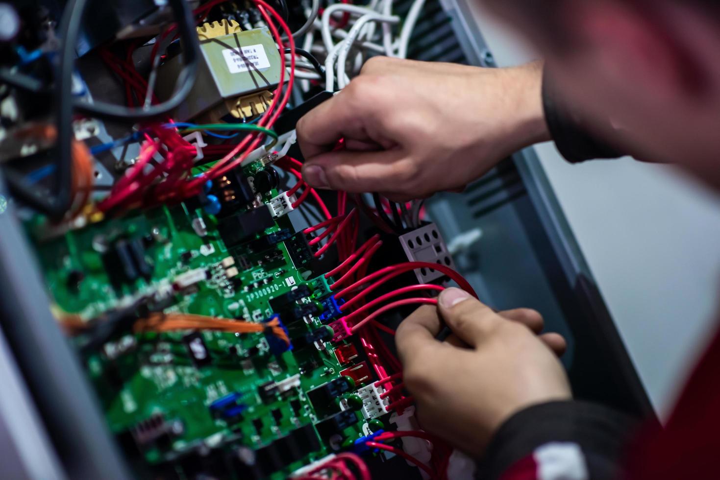 electrician engineer working with electric cable wires photo