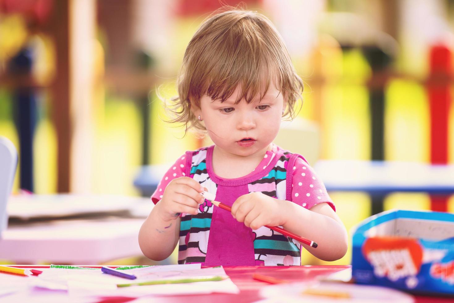 little girl drawing a colorful pictures photo