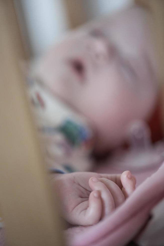 newborn baby sleeping  at home in bed photo