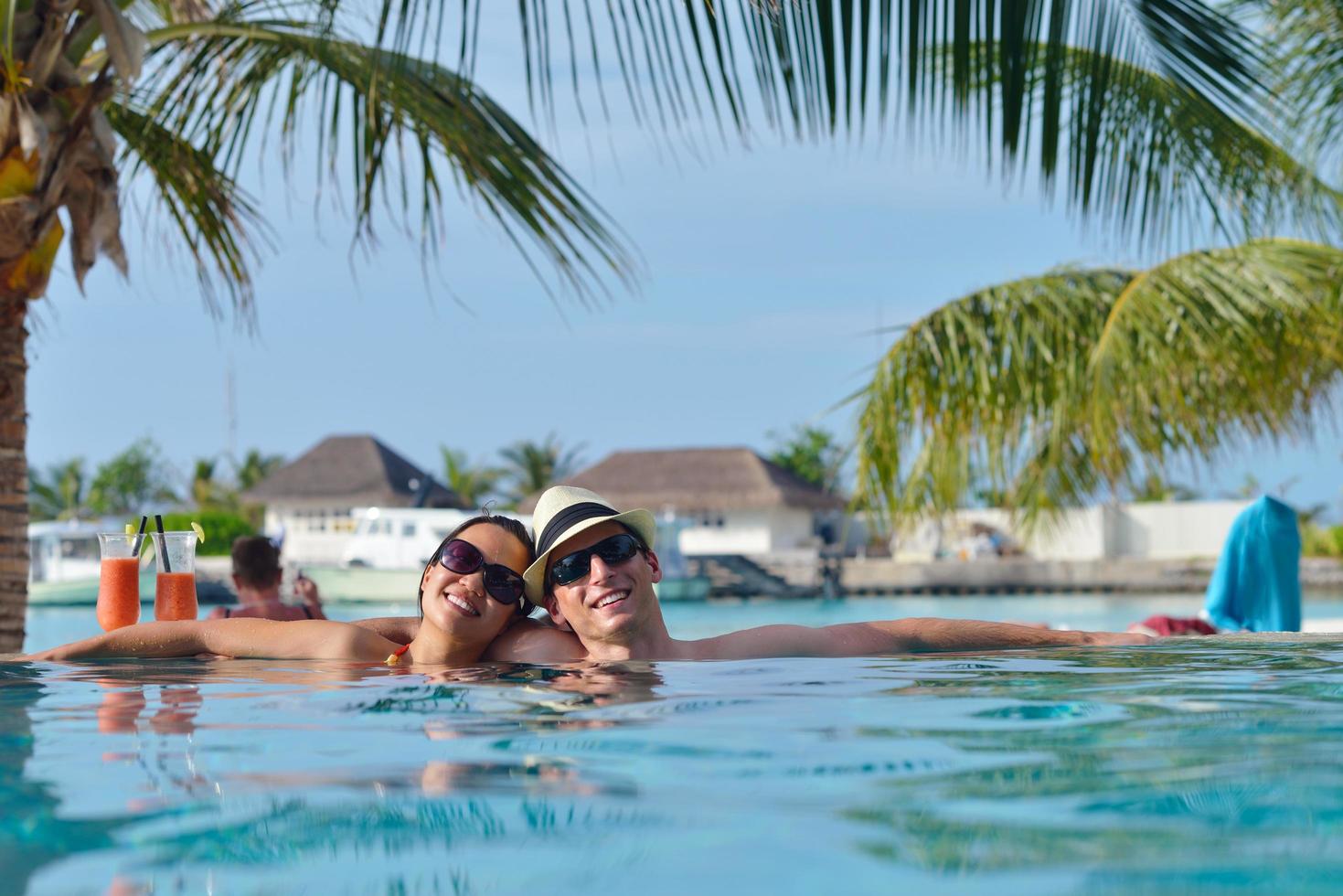 happy young couple have fun on beach photo