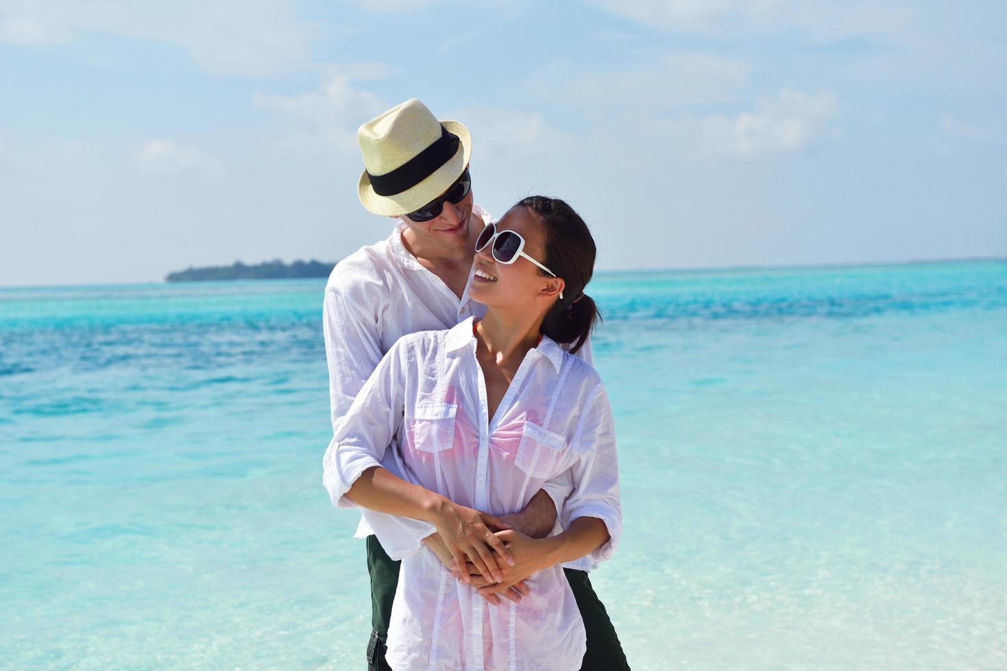 happy young couple have fun on beach photo
