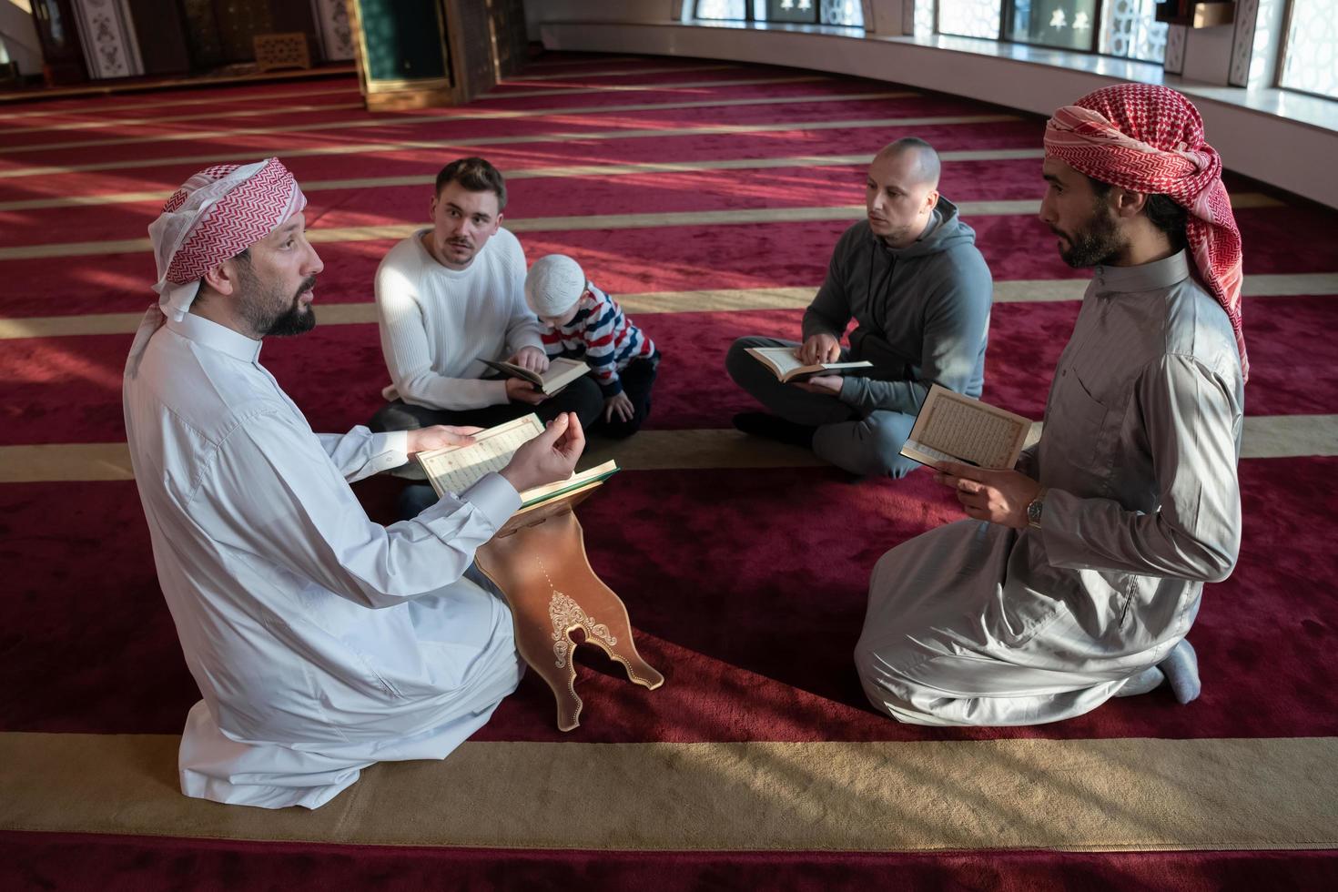 muslim people in mosque reading quran together photo