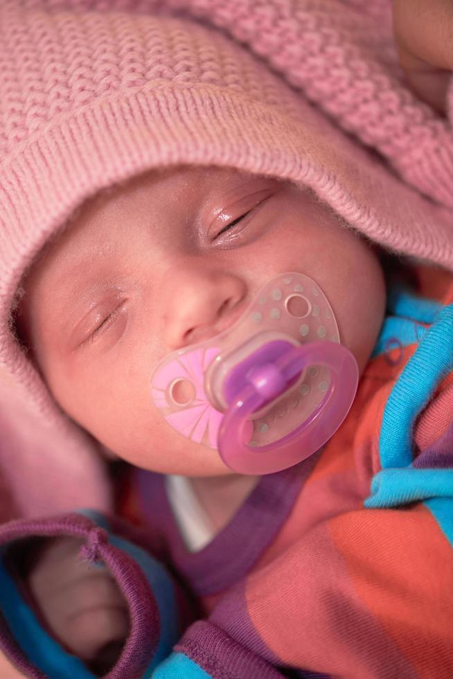 One month newborn baby sleeping  in bed photo